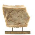 Fragment of a table with a carved rim, depicting a lion attacking a donkey